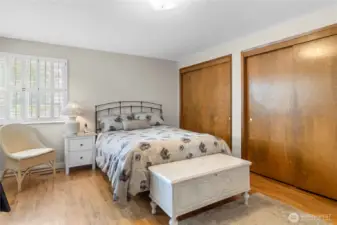 Spacious main floor primary bedroom with en suite and double closets
