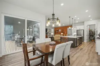 From the dining table, you can see it all. The kitchen island, the living room, and the patio just beyond the sliding doors. This is a space made for dinners that turn into long conversations.