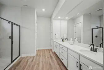 This photo barely scratches the surface. The primary bathroom offers a huge double vanity with tons of storage, a walk-in shower, a storage closet, and a private water closet that makes mornings run smoother.