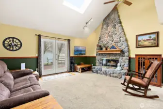 The rock fireplace is a showstopper with the vaulted ceilings
