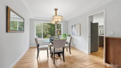 Separate dining room looks out to lush backyard. The enclosed Catio (behind window on right side) provides the perfect opportunity for your indoor kitty to enjoy fresh air!