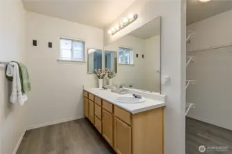 Primary bathroom with dual sinks, walk-in closet