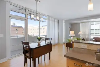 Dining area has a glass door for access to a deck facing the City and Shipyard.