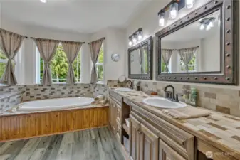 Upper Level 1 - Main Bath features large double sink vanity, soaker tub, shower and ample storage.