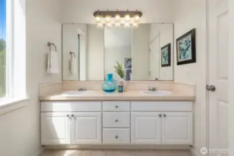 Dual vanity and soaking tub in the primary suite.