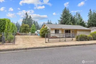 This generous 9,720 square foot lot is fully fenced, with RV parking and a large, expandable gate.