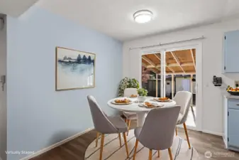 Dining area that opens to the kitchen, featuring durable and stylish updated LVP flooring.
