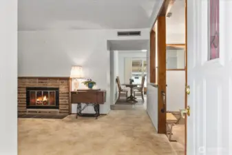 Enter to a welcoming main living area anchored by a wood-burning fireplace, perfect for cozy evenings.