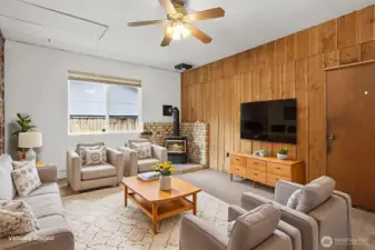 Additional living space with a gas fireplace and fan.