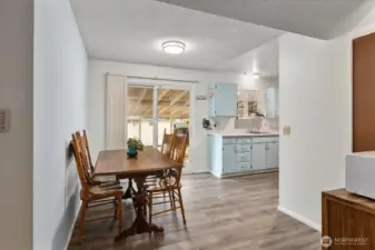 Dining area that opens to the kitchen, featuring durable and stylish updated LVP flooring.