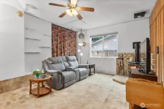 Additional living space with a gas fireplace and fan.