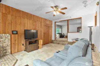 Additional living space with a gas fireplace and fan.
