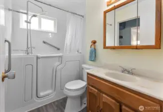 Bathroom updated in 2024 with a new sitting bathtub. Bathroom also features LVP flooring. Access the bathroom from the hallway and the main bedroom.