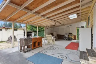 Enjoy outdoor living with a covered back patio, sheds for added storage, and space to garden or relax.
