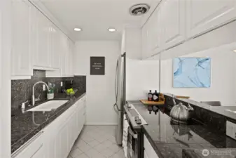 Everything is within easy reach in the kitchen with granite counter tops, new fridge and stove/oven.