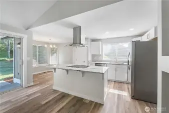 ~Gorgeous new kitchen with white cabinetry, quartzite countertops, stainless-steel appliances, a large island, and a pantry~