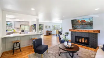 The living room features a cozy wood burning fireplace with a custom mantle and open sight lines throughout the main living spaces - great for everyday living and entertaining.