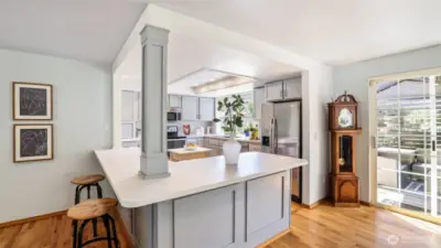 This open kitchen boasts abundant natural light and a welcoming layout perfect for any gathering.
