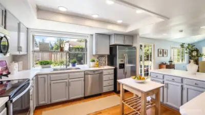 This kitchen features modern appliances, generous counter space, and sleek cabinetry.
