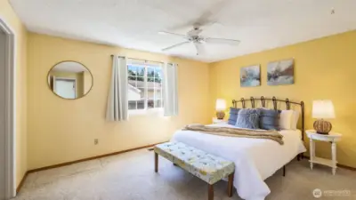 This spacious primary offers a walk-in closet, 3/4 bath en suite and space for a sitting area.