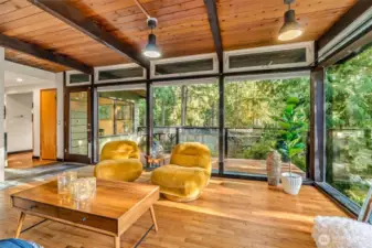 Hardwoods and glass create a seamless connection between your home and the forest outside.