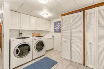 Large laundry room with endless closets for storage.