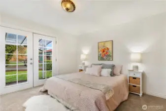 Main floor bedroom with French doors to side yard