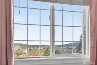 Wake up to serene views of the Guemes Channel right from your primary suite