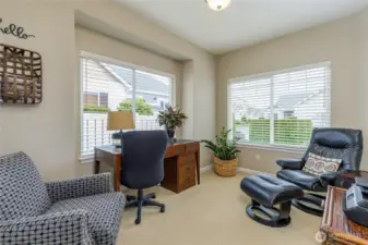 The sun-drenched den/office offers a flexible space for work, hobbies, or a cozy reading nook