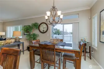 Dining room just off the kitchen has slider to covered back deck