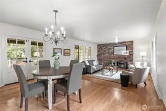 The kitchen is open to the informal dining area and family room. The French doors open to the covered deck and fenced lawn area.