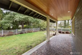 Covered back patio/porch area and the fenced area perfect for pets.