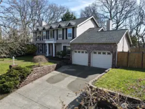 Another view of home and side yard with gate.