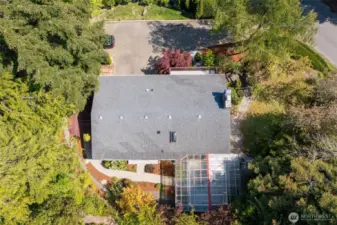 Take it all in from above! The sheer size of that covered back deck is amazing! And see that paved pathway? It's a fantastic feature, connecting both back bedrooms directly to the outdoors and that incredible deck.