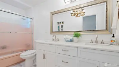 Double the convenience and style in the main bathroom! Featuring a huge, nearly new double vanity and beautiful LVP flooring, updated in 2023.