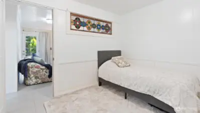 Discover extra living space! This is one of two bonus rooms downstairs; it's currently serving as a bedroom.