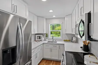 Kitchen was updated with stainless steel appliances, new cabinets, quartz counters