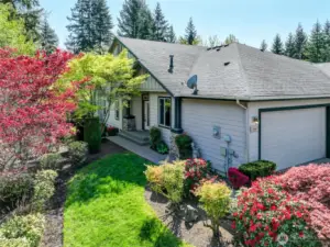 Set on a sunny corner lot with a greenspace behind, everywhere you look from inside the house you see greenery.