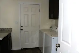 Dedicated laundry room with built in storage!