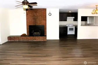 View of living and dining room, looking into kitchen.