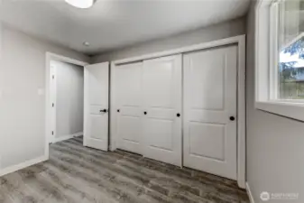 second bedroom featuring wide closets with triple sliding doors