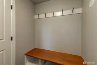 Functional and tidy mudroom with built-in bench seating and convenient wall hooks