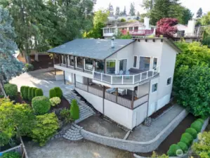 Beautifully maintained multi-level home with expansive wraparound deck. Surrounded by mature landscaping and lush greenery.