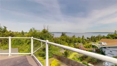 Enjoy panoramic water and tree-lined territorial views from the comfort of your private deck with glass railing.