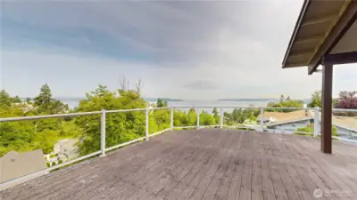 Expansive private deck off the primary suite with breathtaking Puget Sound views.