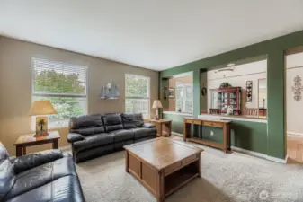 ATTRACTIVE LIVING ROOM IS PERFECT SIZE FOR HOSTING FRIENDS, AND FUN.