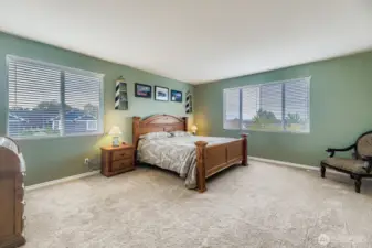 RESTFUL PRIMARY BEDROOM EASILY FITS A KING SIZE BED WITH ROOM FOR FURNITURE, AMAZING NATURAL LIGHTING.