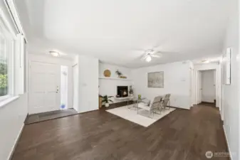 View of living area from kitchen nook.  Wood burning fireplace with insert and fully Tiled mantel