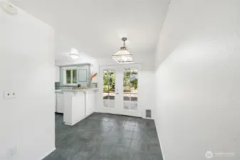 Kitchen nook with french doors that lead to a private covered pateo and yard.