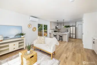 Warm hued wide, luxury vinyl plank flooring is a great accent to this neutral palate.